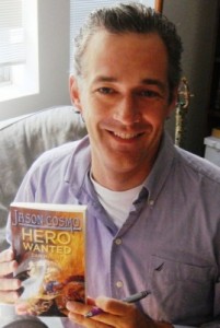 Dan McGirt holds a copy of his book Hero Wanted